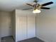 The bedroom includes a fan and a closet for ample storage at 1441 Bronco Rd, Boulder City, NV 89005