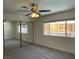 Bedroom features ceiling fan, window overlooking the backyard, and large closet at 1441 Bronco Rd, Boulder City, NV 89005