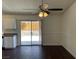 The dining area features wood floors, a ceiling fan, and sliding glass doors to the backyard at 1441 Bronco Rd, Boulder City, NV 89005