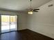 The dining area features wood floors, a ceiling fan, and sliding glass doors to the backyard at 1441 Bronco Rd, Boulder City, NV 89005