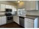 Bright kitchen features stainless steel appliances and white cabinetry at 1441 Bronco Rd, Boulder City, NV 89005