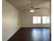 The living room features a ceiling fan, wood floors, and bright natural lighting at 1441 Bronco Rd, Boulder City, NV 89005