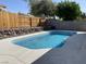 An inviting pool with a pristine concrete patio and privacy fence at 1441 Bronco Rd, Boulder City, NV 89005