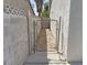 This side yard features a gravel area enclosed by block wall at 1441 Bronco Rd, Boulder City, NV 89005