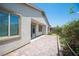 Sliding glass doors lead to a brick patio with mature landscaping around the border at 1617 Meadow Bluffs Ave, Henderson, NV 89014
