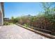Brick patio with mature landscaping around the border at 1617 Meadow Bluffs Ave, Henderson, NV 89014