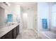 Bright bathroom featuring a double sink vanity, bathtub, and separate glass shower at 1617 Meadow Bluffs Ave, Henderson, NV 89014