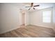 Bright, airy bedroom with wood-look floors, a ceiling fan, a double door closet, and natural light from the window at 1617 Meadow Bluffs Ave, Henderson, NV 89014