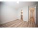 Bright bedroom showcasing wood-look flooring and a walk-in closet, providing a comfortable living space at 1617 Meadow Bluffs Ave, Henderson, NV 89014