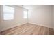 This bedroom features wood-look flooring and two windows that provide natural light at 1617 Meadow Bluffs Ave, Henderson, NV 89014