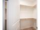 Spacious walk-in closet with wooden clothing rods and a built-in shelf at 1617 Meadow Bluffs Ave, Henderson, NV 89014