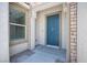Close-up of front entrance featuring a blue door, stone accents, and a sidelight window at 1617 Meadow Bluffs Ave, Henderson, NV 89014