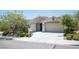 Charming single-story home with stone accents, a two-car garage, and a well-maintained landscaped front yard at 1617 Meadow Bluffs Ave, Henderson, NV 89014