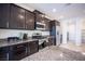 Well-equipped kitchen with stainless steel appliances and dark wood cabinets at 1617 Meadow Bluffs Ave, Henderson, NV 89014