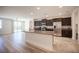 Open-concept kitchen featuring a granite island, stainless steel appliances, and dark wood cabinetry with sleek hardware at 1617 Meadow Bluffs Ave, Henderson, NV 89014