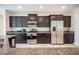 Modern kitchen with stainless appliances, granite countertops, and ample cabinet space at 1617 Meadow Bluffs Ave, Henderson, NV 89014