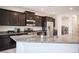 Close-up of a kitchen island featuring a granite countertop and stainless steel sink and faucet at 1617 Meadow Bluffs Ave, Henderson, NV 89014