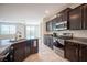 Well-equipped kitchen with granite counters, stainless steel appliances, and dark cabinetry at 1617 Meadow Bluffs Ave, Henderson, NV 89014