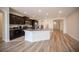 Kitchen with granite countertops and stainless steel appliances flows seamlessly into the living area at 1617 Meadow Bluffs Ave, Henderson, NV 89014