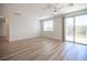 Living room featuring wood-style floors, a sliding door, and a large window at 1617 Meadow Bluffs Ave, Henderson, NV 89014