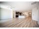 Spacious living room with wood-style flooring, connecting seamlessly with an adjacent kitchen area at 1617 Meadow Bluffs Ave, Henderson, NV 89014