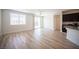 Open-concept living room with wood-style floors and sliding door to the outdoor space at 1617 Meadow Bluffs Ave, Henderson, NV 89014