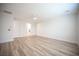 Spacious main bedroom featuring wood-look floors, a ceiling fan, and ensuite bathroom at 1617 Meadow Bluffs Ave, Henderson, NV 89014