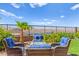 Outdoor seating area with lake views, a fire pit, and landscaped yard at 163 Caraset Ln, Henderson, NV 89011