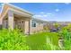 Beautiful backyard with artificial grass, desert landscaping and covered patio at 163 Caraset Ln, Henderson, NV 89011
