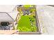 The backyard featuring a covered patio, outdoor seating, and artificial grass at 163 Caraset Ln, Henderson, NV 89011