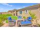Brick-paved backyard patio area with comfy furniture and manicured plants at 163 Caraset Ln, Henderson, NV 89011