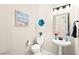 Bathroom with boat artwork, bright lighting, neutral walls, and a stand sink at 163 Caraset Ln, Henderson, NV 89011