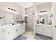Luxurious bathroom with dual vanities, quartz countertops, modern fixtures, and a glass-enclosed shower at 163 Caraset Ln, Henderson, NV 89011
