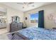 Inviting bedroom with a stylish ceiling fan, blue curtains, and a designer dresser at 163 Caraset Ln, Henderson, NV 89011