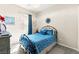 Cozy bedroom with a wrought iron bed frame, blue bedding, and natural light at 163 Caraset Ln, Henderson, NV 89011