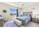 Comfortable bedroom with a large window, ceiling fan, and mountain views at 163 Caraset Ln, Henderson, NV 89011
