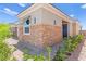 Exterior view of the house with stone accents, a small garden, and an attached garage at 163 Caraset Ln, Henderson, NV 89011