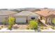 Charming single-story home with a stone facade, well-maintained landscaping, and a two-car garage at 163 Caraset Ln, Henderson, NV 89011