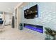 Modern fireplace with multicolored tiled wall and adjacent kitchen at 163 Caraset Ln, Henderson, NV 89011