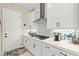 Bright kitchen with quartz counters, stainless appliances, custom tile backsplash and access to a backyard at 163 Caraset Ln, Henderson, NV 89011