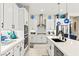 Modern kitchen with stainless steel appliances, white cabinetry, and stylish blue accents at 163 Caraset Ln, Henderson, NV 89011