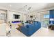 Cozy living room with a modern fireplace, stylish decor, and a comfortable blue sofa at 163 Caraset Ln, Henderson, NV 89011