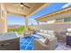 Cozy covered patio with comfortable seating and a built-in grill, perfect for entertaining at 163 Caraset Ln, Henderson, NV 89011