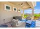 Relaxing outdoor patio with comfortable seating, ceiling fan, and decorative wall art at 163 Caraset Ln, Henderson, NV 89011