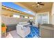 Inviting outdoor patio with plush seating, grill, and sliding door entrance at 163 Caraset Ln, Henderson, NV 89011
