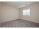 Simple bedroom boasts soft carpet, recessed lights, and a window bringing the outside in at 1633 Dornie Ave, North Las Vegas, NV 89084