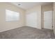 Comfortable carpeted bedroom with a closet, neutral color, and a bright window at 1633 Dornie Ave, North Las Vegas, NV 89084