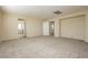 Large bedroom with neutral walls, carpeted floor, and openings to other rooms at 1633 Dornie Ave, North Las Vegas, NV 89084