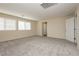 Sunny bedroom with plush carpet, large windows, and neutral paint at 1633 Dornie Ave, North Las Vegas, NV 89084