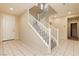 Spacious entryway featuring tiled floor, staircase with white railing, and coat closet at 1633 Dornie Ave, North Las Vegas, NV 89084